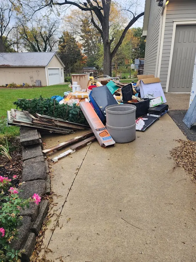 Dumpster being loaded with debris for Estate Cleanout Dumpster Rental in Mount Olive